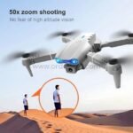 E99 Pro Foldable Drone flying over sand dunes, using its 50x zoom to capture detailed shots of a person below.