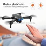 E99 Pro Foldable Drone mid-air, responding to hand gestures like open palms for hands-free photo capture.