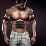 A man using the EMS 6-pack abs trainer on his abs and arms, highlighting its ergonomic design and ease of use.