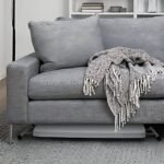Folding coffee table stored flat under a sofa, highlighting its compact, space-saving design.