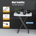 Folding coffee table supporting heavy dumbbells, highlighting its 110 lb weight capacity.