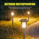 Three solar garden pathway lights illuminated in rainy conditions, showcasing their waterproof design.