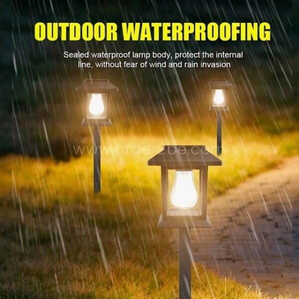 Three solar garden pathway lights illuminated in rainy conditions, showcasing their waterproof design.