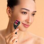 A woman gently using a black derma roller with a purple needle head on her face for effective skin rejuvenation.