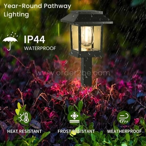 A solar garden pathway light illuminated during rainfall, showcasing its IP44 waterproof rating.