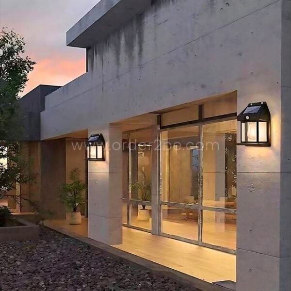 Black security motion sensor lamps illuminating a modern building entrance.