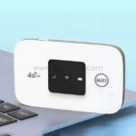 White wireless 4G Wi-Fi router on a laptop keyboard, showcasing portability and high-speed connectivity for work or travel.