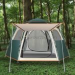 Automatic pop-up camping tent set up in a lush forest, showcasing its spacious interior and sturdy design.