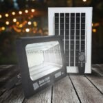 GD SUPER 100W solar flood light illuminating an outdoor area at night.