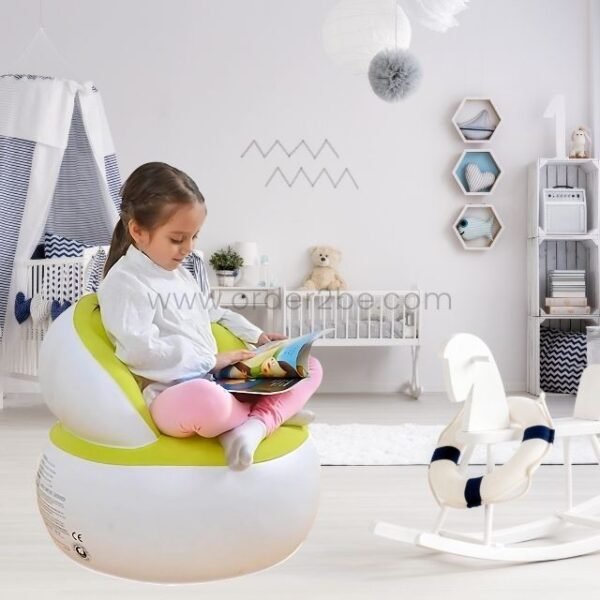 A girl reading in an inflatable chair in kids' room.