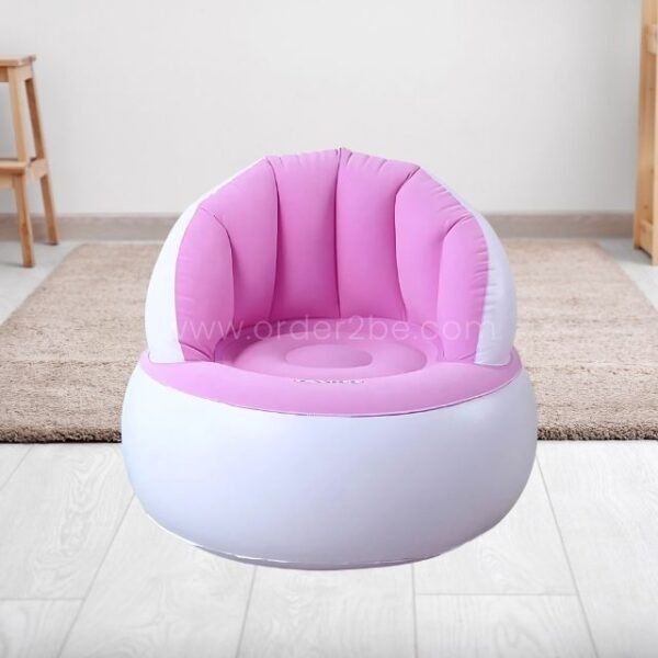 A pink inflatable chair on a wooden floor in a minimalist room.