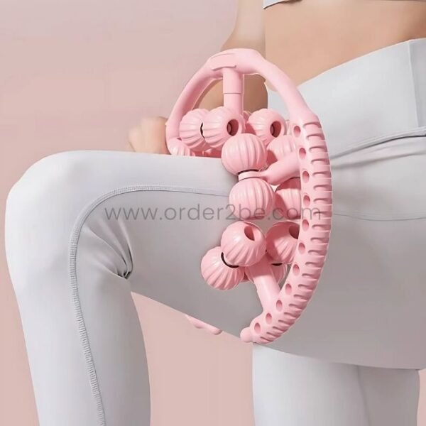 Woman using the pink handheld massager with multiple rollers to massage her thigh.