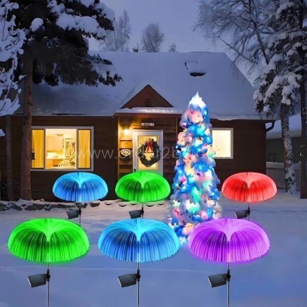Jellyfish solar garden lights glowing around a snowy Christmas tree, adding festive vibes.