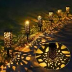 Creative solar garden lights casting mesmerizing shadows on a garden pathway, enhancing the ambiance.