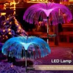 Colorful jellyfish solar garden lights glowing against snowy patio decor.