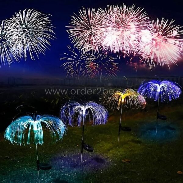 Jellyfish solar garden lights glowing in a field beneath a real fireworks display, colors reflecting in sync.