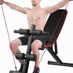 A man using the multi-functional home gym bench with resistance bands for an upper-body workout.