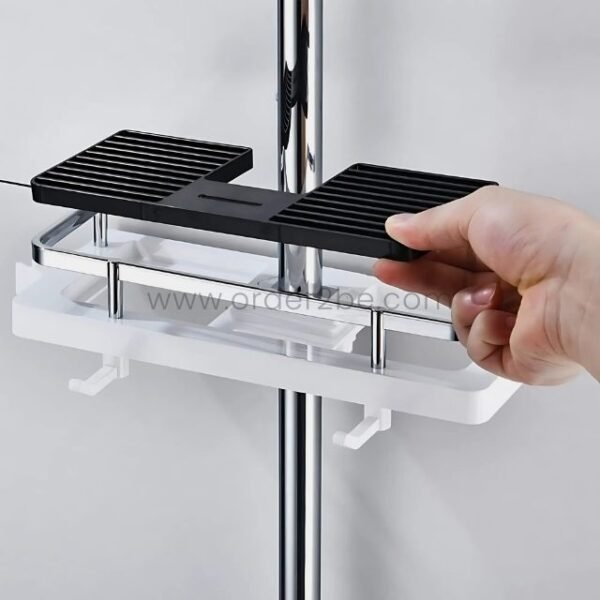 Hand repositioning the tray on a space-saving shower caddy for custom storage.