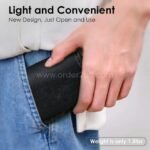 Person holding the folded camping chair in their pocket, showcasing its lightweight design (only 1.5 lbs).