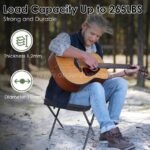 Man sitting on the black camping chair playing guitar outdoors, highlighting its load capacity of up to 265 lbs.