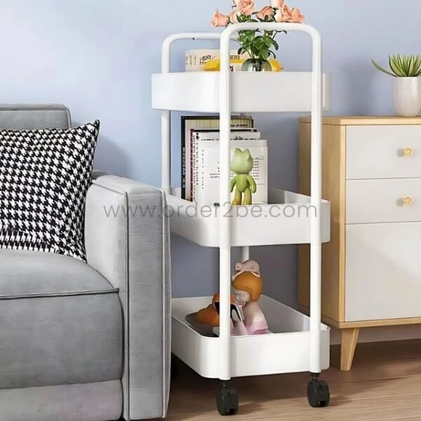White 3-tier rolling organizer holding books, toys, and decor in a modern living area.