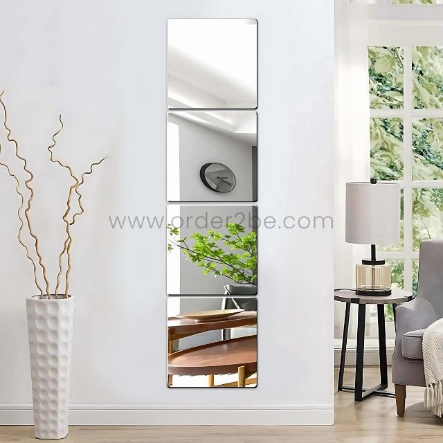 Vertical stack of 30x30cm peel-and-stick mirror tiles reflecting cozy modern decor and soft daylight.