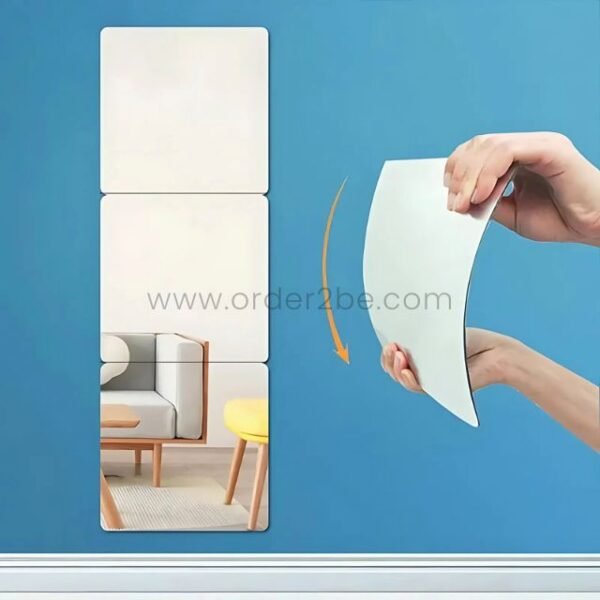 A person arranging 30x30cm mirror tiles in a creative layout on a modern wall.