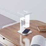 Modern dimmable desk lamp beside an open book for nighttime reading or study.