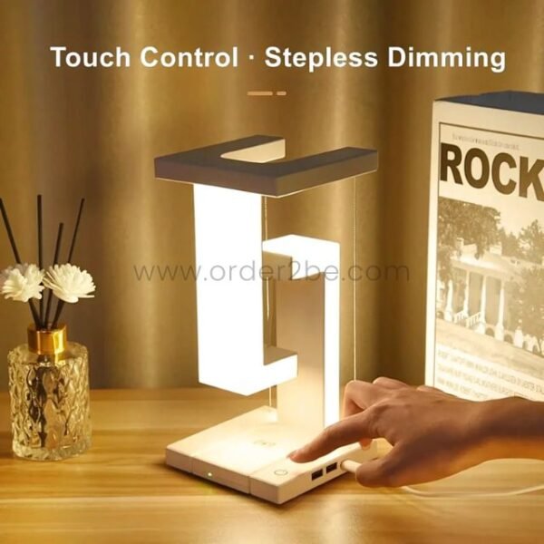Hand using touch controls on a modern dimmable desk lamp for stepless brightness adjustment.