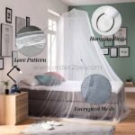 White bed mosquito net over a bed with lace accents and fine encrypted mesh detail.