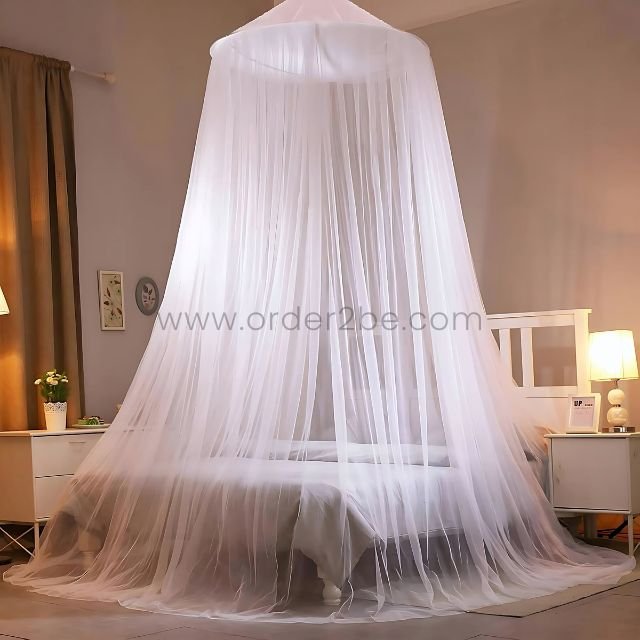 White bed mosquito net draped over a neatly made bed in a cozy, softly lit bedroom.