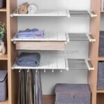 Adjustable Shelf Organizer installed in a closet, holding folded clothes and accessories.