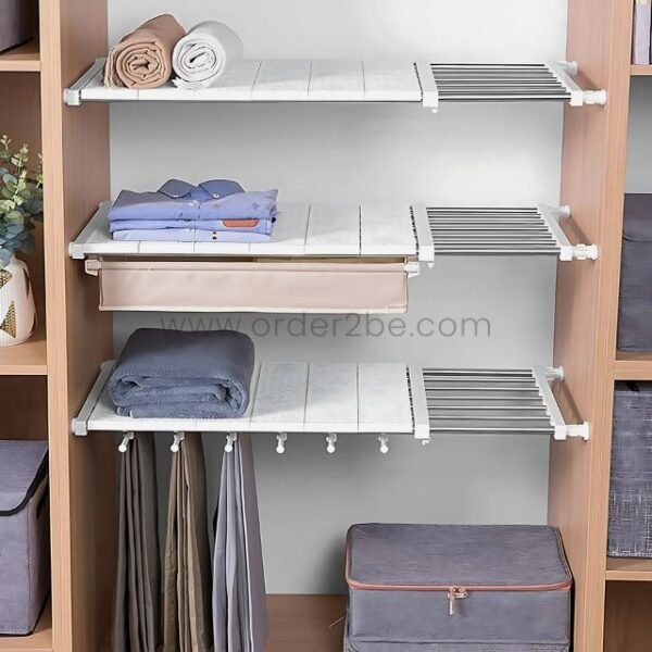 Adjustable Shelf Organizer installed in a closet, holding folded clothes and accessories.