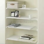 Adjustable Shelf Organizer installed in a living room closet, holding folded clothes and decorative bins.
