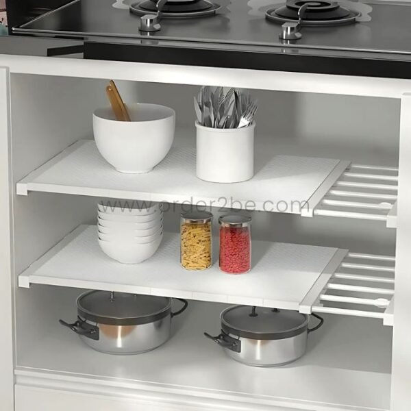Adjustable Shelf Organizer storing bowls, jars, and kitchen containers inside a cabinet.