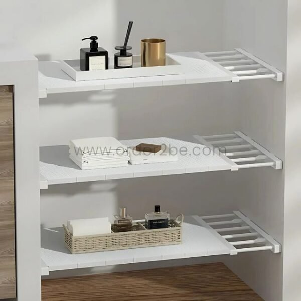 Adjustable Shelf Organizer installed between a bathroom wall and cabinet, holding towels and containers.