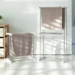 2-Tier laundry drying rack beside a single-tier version, both catching natural light in a bright room.