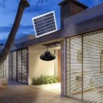 Outdoor solar pendant light mounted under eaves of a modern home, lighting the entryway.