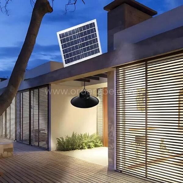 Outdoor solar pendant light mounted under eaves of a modern home, lighting the entryway.
