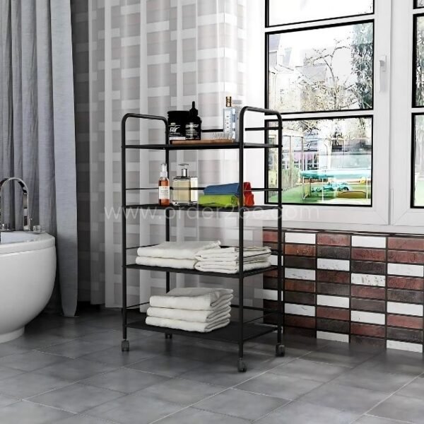Portable multi-shelf storage rack with wheels, placed beside a bathtub and window, storing towels, toiletries, and a folded blanket.