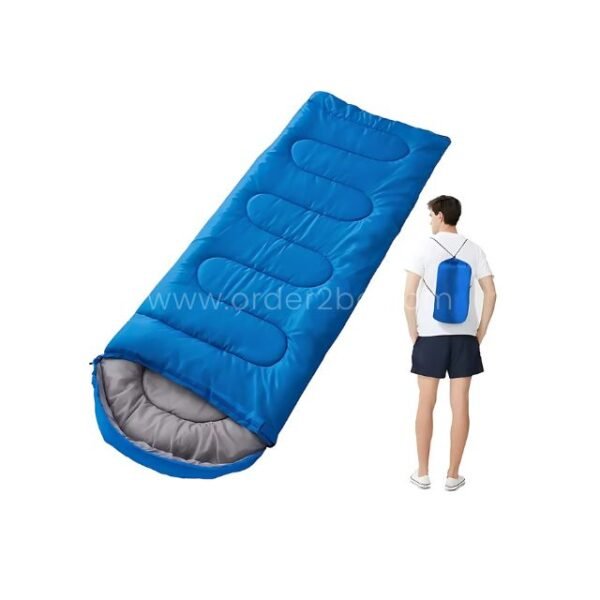 Blue portable sleeping bag on a white backdrop next to a backpack-wearing person, showing its travel-friendly size.