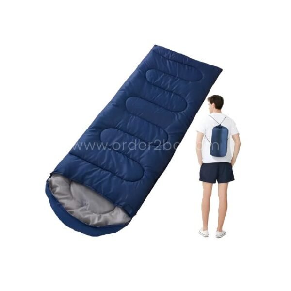 Blue portable sleeping bag placed on a white background beside a standing person, demonstrating its lightweight design.