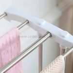 Close-up of 2-tier laundry drying rack’s metal frame and white plastic joints.