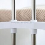 Tight shot of white connectors locking into the 2-tier laundry drying rack’s metal frame.
