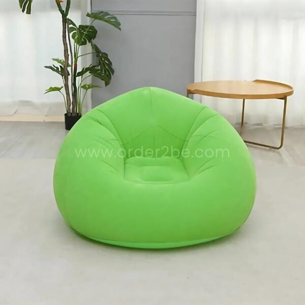 Green inflatable bean bag chair in a bright living area next to a coffee table, portable and supports adults.