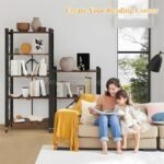 Woman and child reading on a couch beside two black storage racks filled with books and decor.