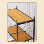 Close-up of wooden shelf with 34 cm depth, framed in black steel, marked with measurement label.