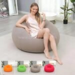Inflatable bean bag chair in gray, shown in a bright modern living room with multiple color options displayed, lightweight and easy to inflate.