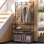 Modern entryway shoe rack with coat hooks, three-tier shoe shelves, and boots on wooden floor.