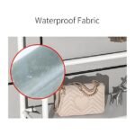 Waterproof fabric shelf on black metal rack with water droplets beading, holding a handbag.